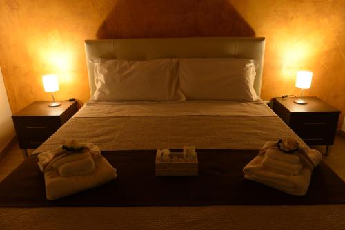 a bedroom with a bed with two towels on it at Dimora Civitas Severiana in Montescaglioso