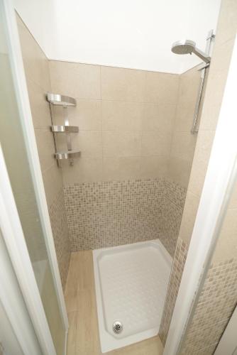 a bathroom with a shower with a white tub at Dimora Civitas Severiana in Montescaglioso