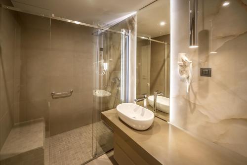 a bathroom with a sink and a shower at Hotel Maritime in Krk