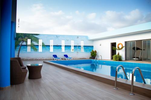 a swimming pool with a view of the ocean at Le Ndiambour Hôtel et Résidence in Dakar