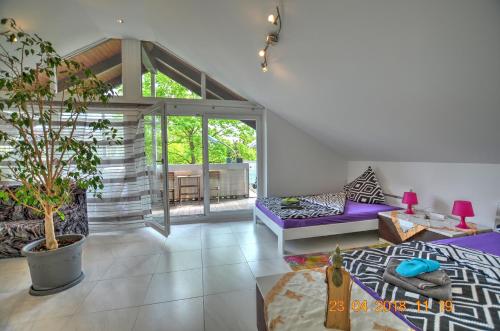 a living room with purple furniture and a large window at Ferienwohnung"VIP MUNICH ALBATROS DE LUXE" in Kirchheim