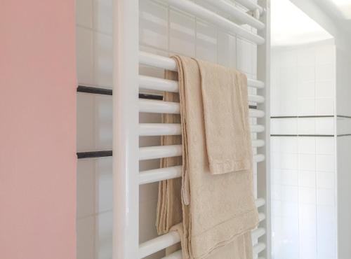 a bathroom with white towels hanging on a towel rack at Agave Room Rental in Riomaggiore