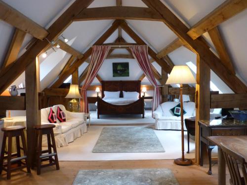 a attic room with two beds and a table at Wooden Cabbage Barn in Dorchester