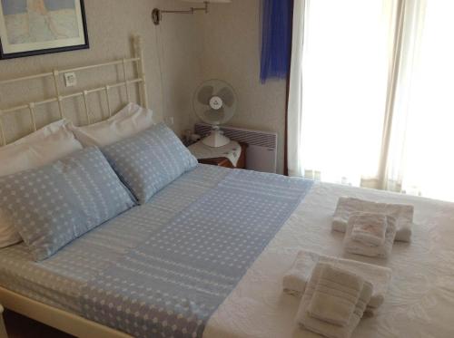 a bed with two pillows on it in a bedroom at Stella's Maisonette in Siviri