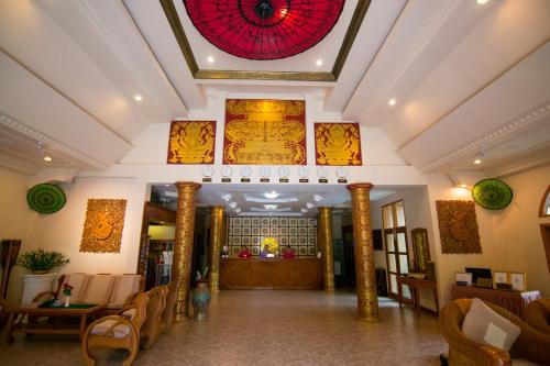 a lobby of a hotel with a red ceiling at The Hotel Umbra Bagan in Bagan