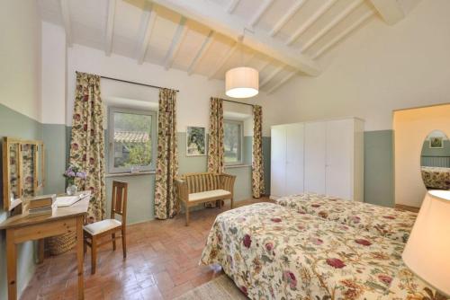 a hotel room with a bed and a desk and a desk at B&B Palazzolo La Foce in Chianciano Terme