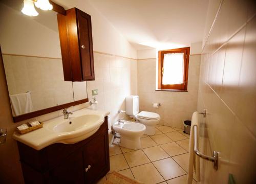 a bathroom with a sink and a toilet at B&B Casalotto Inn in Aci SantʼAntonio