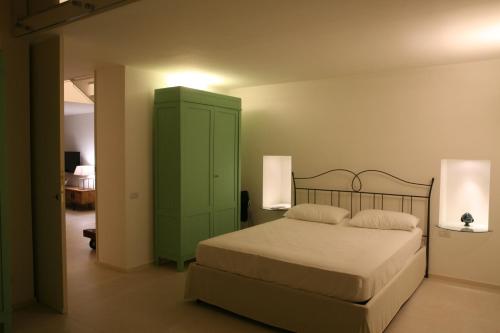 a bedroom with a green cabinet and a bed at Le Tre Vie Apartment & Room in Matera