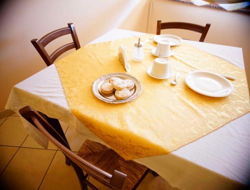 a table with a plate of food on it at B&B Casalotto Inn in Aci SantʼAntonio