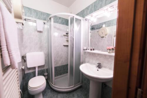 a bathroom with a toilet and a sink and a shower at Hotel Maxim Axial in Florence