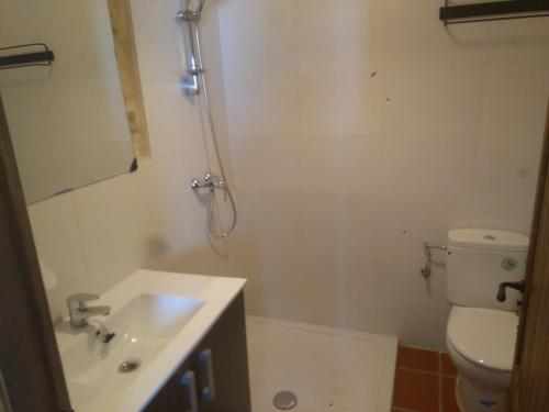 a bathroom with a toilet and a sink at Casa Rural La Tia Rosa in Chulilla