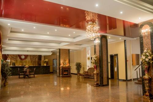 a lobby with a chandelier and a fireplace at Dniprovski Zori in Kremenchuk