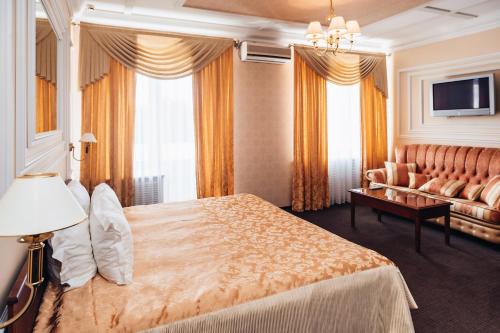 
a hotel room with a bed and a dresser at Nikolaevsky Hotel in Vologda
