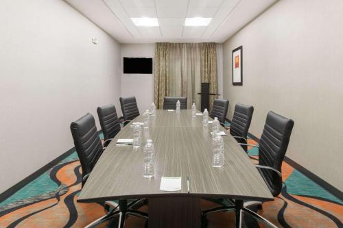 a conference room with a long table and chairs at Wingate by Wyndham Lubbock in Lubbock