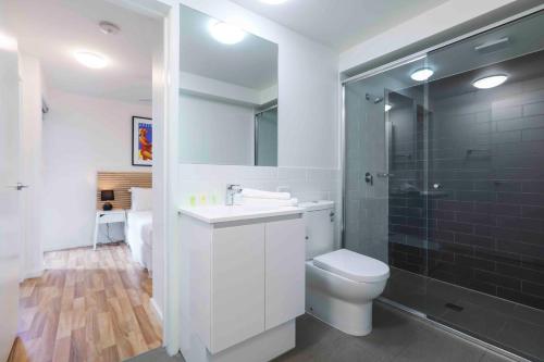 a bathroom with a toilet and a sink and a shower at Sandbox Apartments in Gold Coast