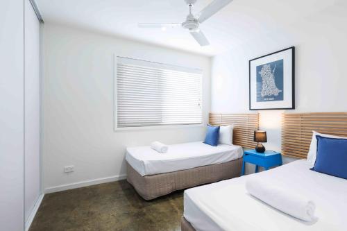 a bedroom with two beds and a window at Sandbox Apartments in Gold Coast