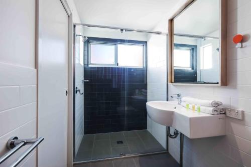 a bathroom with a sink and a shower at Sandbox Apartments in Gold Coast