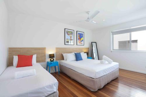 a bedroom with two beds and a window at Sandbox Apartments in Gold Coast
