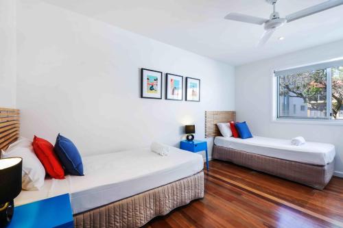 a bedroom with two beds and a window at Sandbox Apartments in Gold Coast