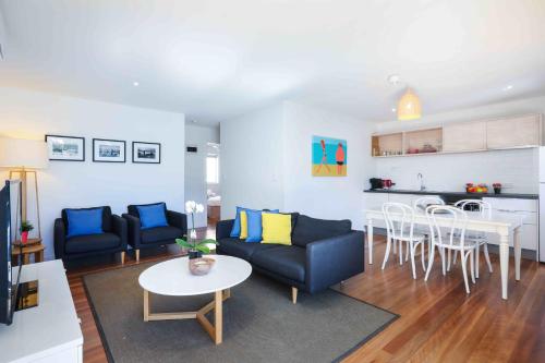 a living room with a couch and a table at Sandbox Apartments in Gold Coast