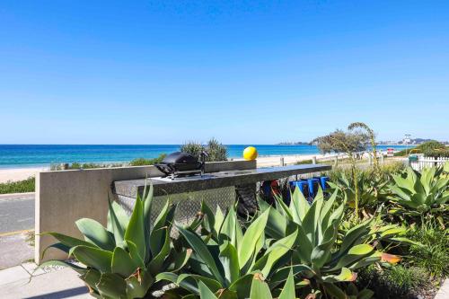 a picnic table on the side of the beach at Sandbox Apartments in Gold Coast