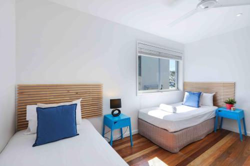 a bedroom with two beds and a window at Sandbox Apartments in Gold Coast