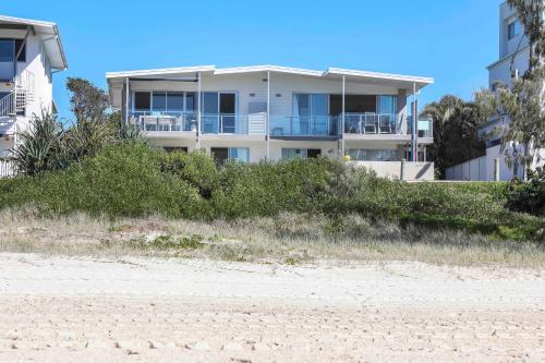 a house on the beach next to the beach at Sandbox Apartments in Gold Coast