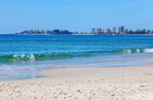 a view of the beach with a city in the background at Sandbox Apartments in Gold Coast