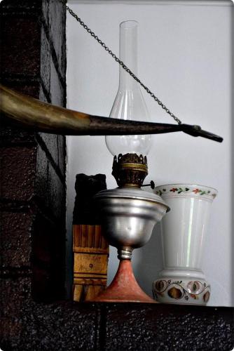 a lamp and a bowl on a shelf with a stick at guest house QEDI in Jvari