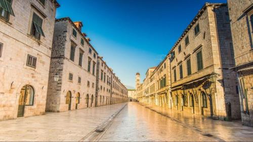 an empty street in an old town with buildings at Villa Madonna della Strada A5 in Dubrovnik
