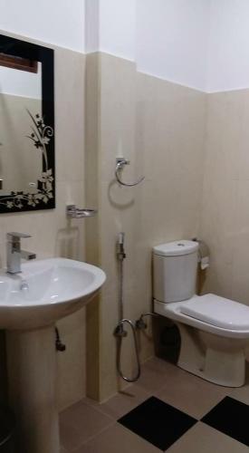 a bathroom with a sink and a toilet at The City Tourist Hotel in Anuradhapura