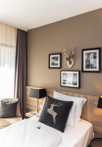 a bedroom with a bed with a deer pillow on it at Best Western Plus Hotel Ostertor in Bad Salzuflen