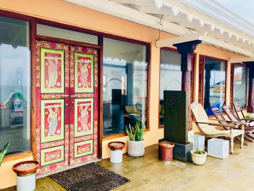 an open door of a house with potted plants at Thaproban Pavilion Waves in Unawatuna