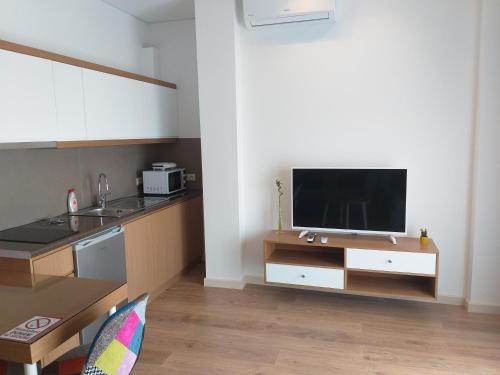 a kitchen with a flat screen tv on a counter at Rustemi in Sarandë