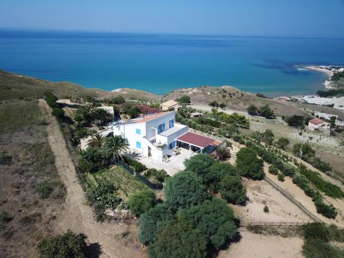 an aerial view of a house on a hill next to the ocean at B&B Monterosso in Realmonte