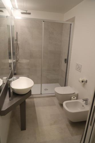 a bathroom with a shower and a sink and a toilet at Promenade Maison de Charme in Sanremo