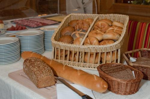 a table with baskets of bread and a basket of bread at Hotel Zur Krone in Beilngries