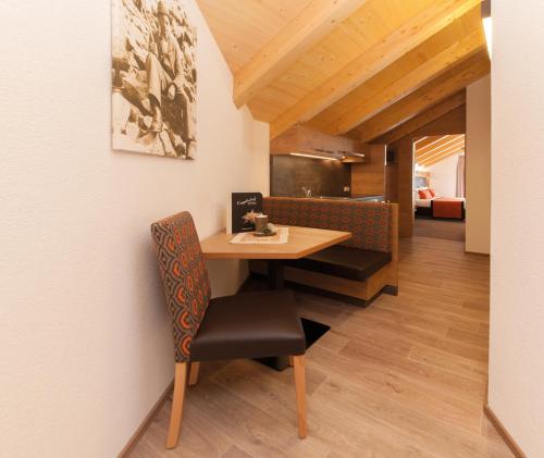 a dining room with a table and a chair at Sport Garni Kapplerhof – Ischgl/Kappl in Kappl