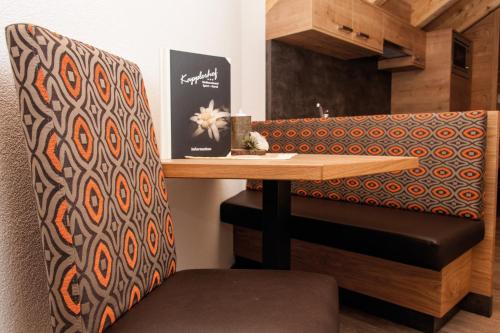 a dining room with a table and a chair at Sport Garni Kapplerhof – Ischgl/Kappl in Kappl
