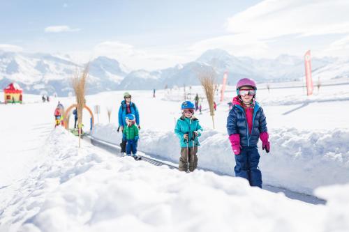 a group of children standing in the snow at Farfalla in Blatten bei Naters
