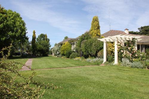 a house with a yard with a gazebo at Historic Merryville Homestead in Murrumbateman