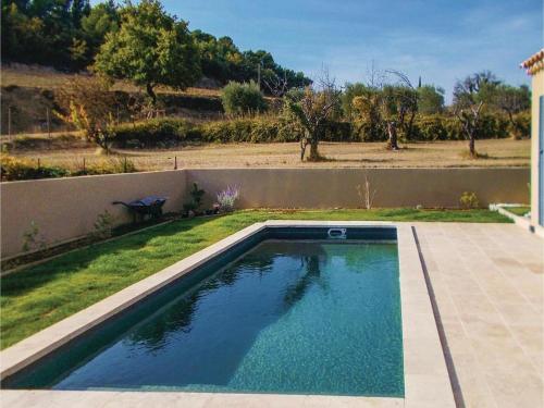 a swimming pool in a yard with a fence at Lou Badabeu in Le Barroux