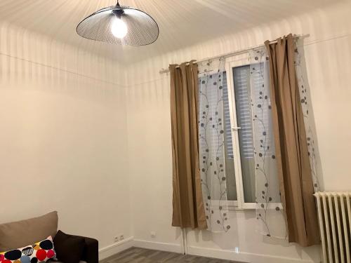 a living room with a window with curtains at Grand F3 Paris Stade de France & La Villette, 6 pers - Metro 7 in Aubervilliers