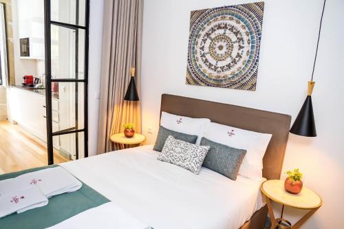 a bedroom with a white bed with two tables at Formosa 168 by Guestify in Porto