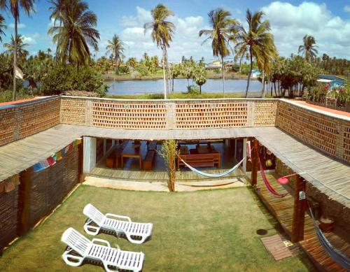 a playground with two white chairs and a slide at Pousada Casa de João Kitehouse in São Miguel do Gostoso