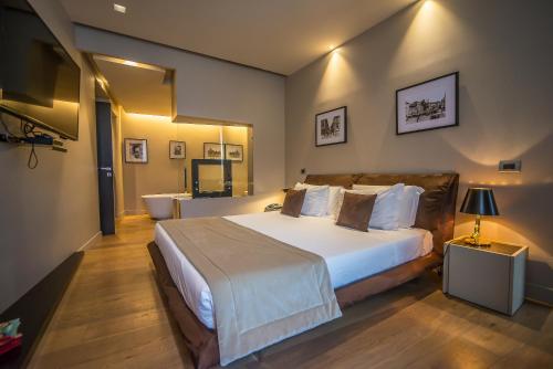 a bedroom with a large bed and a bathroom at Campo Marzio Luxury Suites in Rome