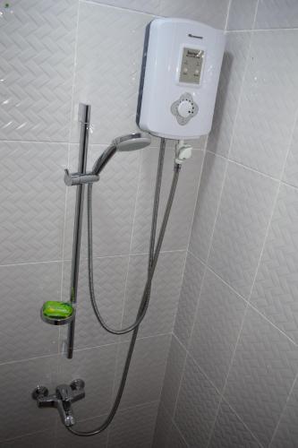 a shower in a bathroom with aitizer at Van Der Salle in Accra