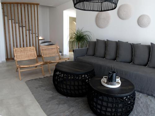a living room with a couch and two tables and chairs at Elements Villas in Lardos