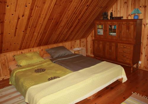 a bedroom with a bed in a wooden room at Chata u Żochów in Stanisławowo