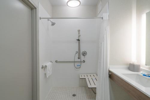 a white bathroom with a shower and a sink at Holiday Inn Express Radcliff Fort Knox by IHG in Radcliff
